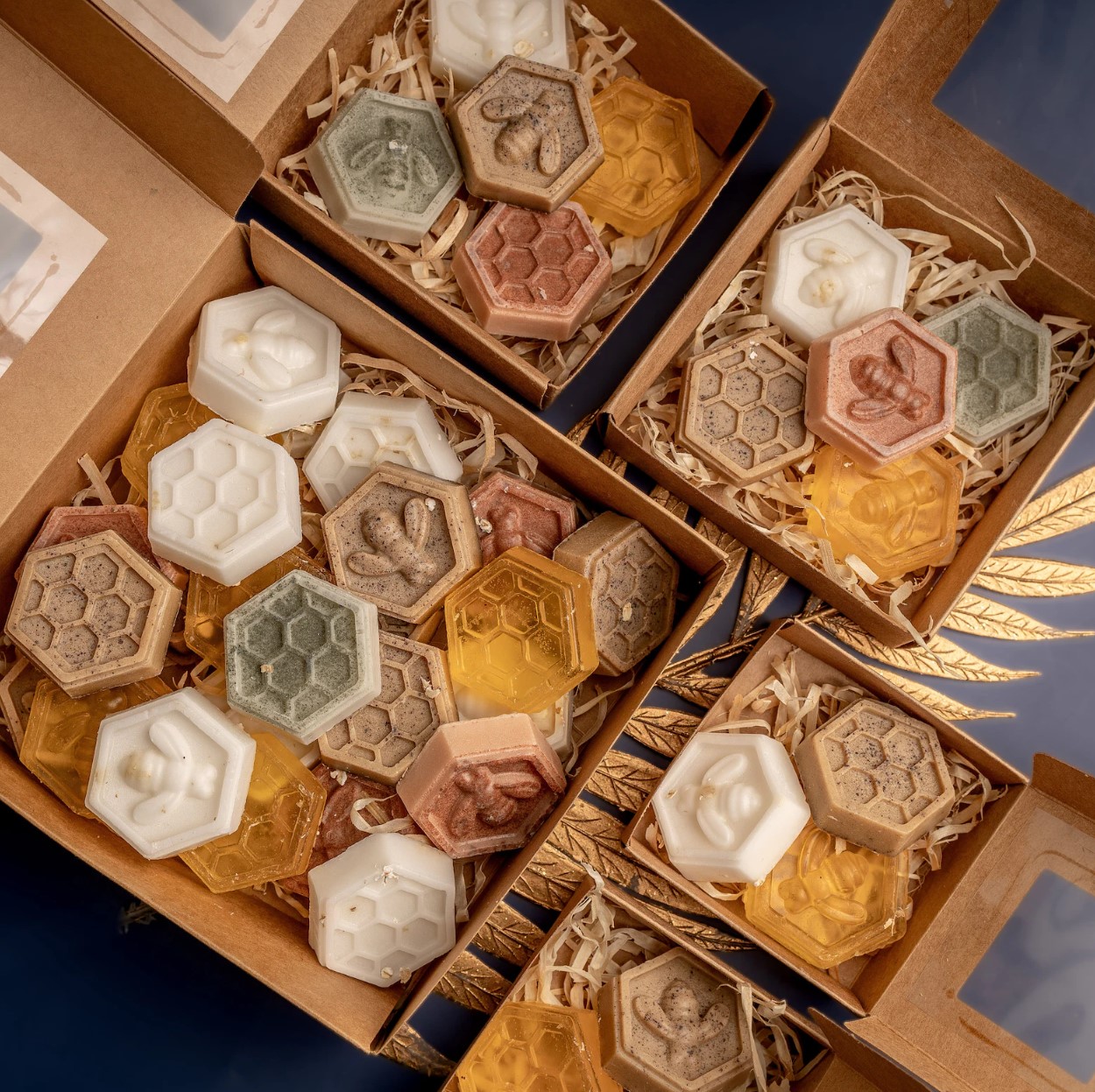 Hexagonal honeycomb and bee soaps in kraft boxes with wood wool