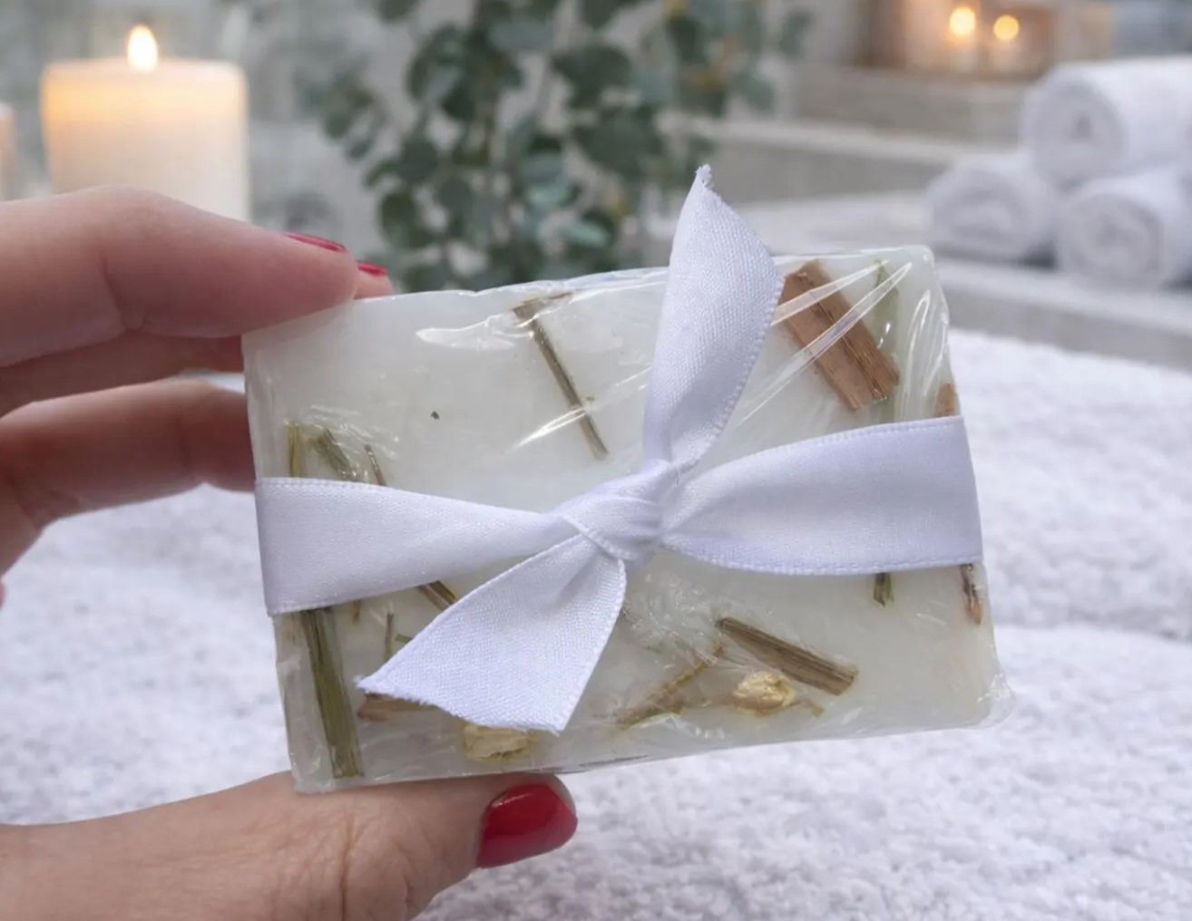Single lemongrass soap bar wrapped in cellophane with a white satin ribbon
