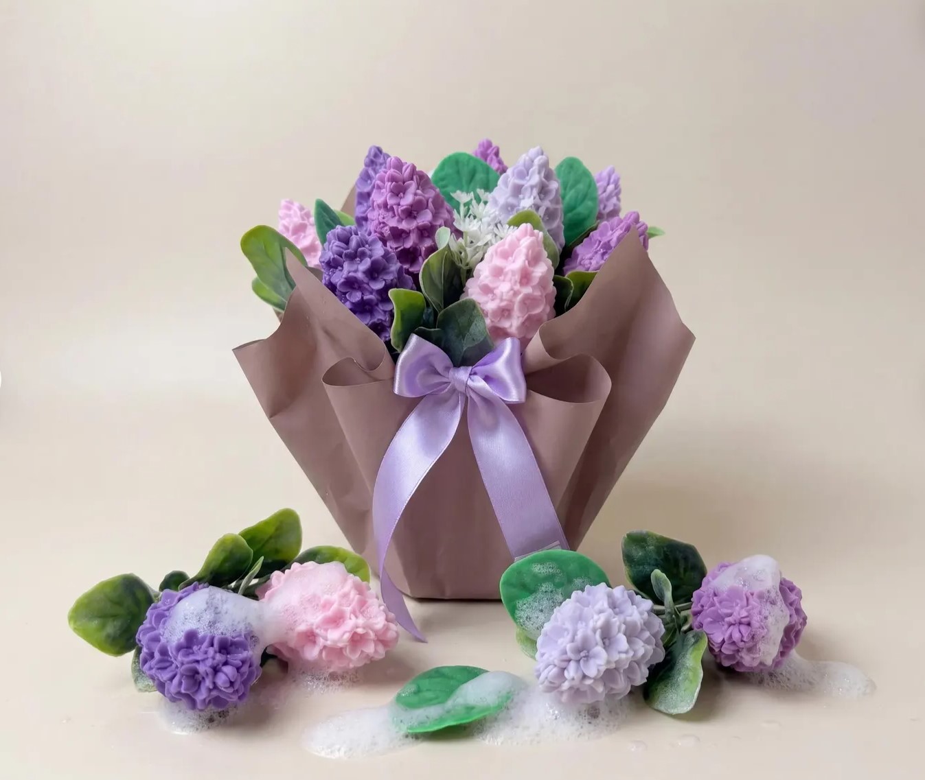 Soap bouquet of purple and pink hyacinth-shaped soaps wrapped in kraft paper with a lilac ribbon