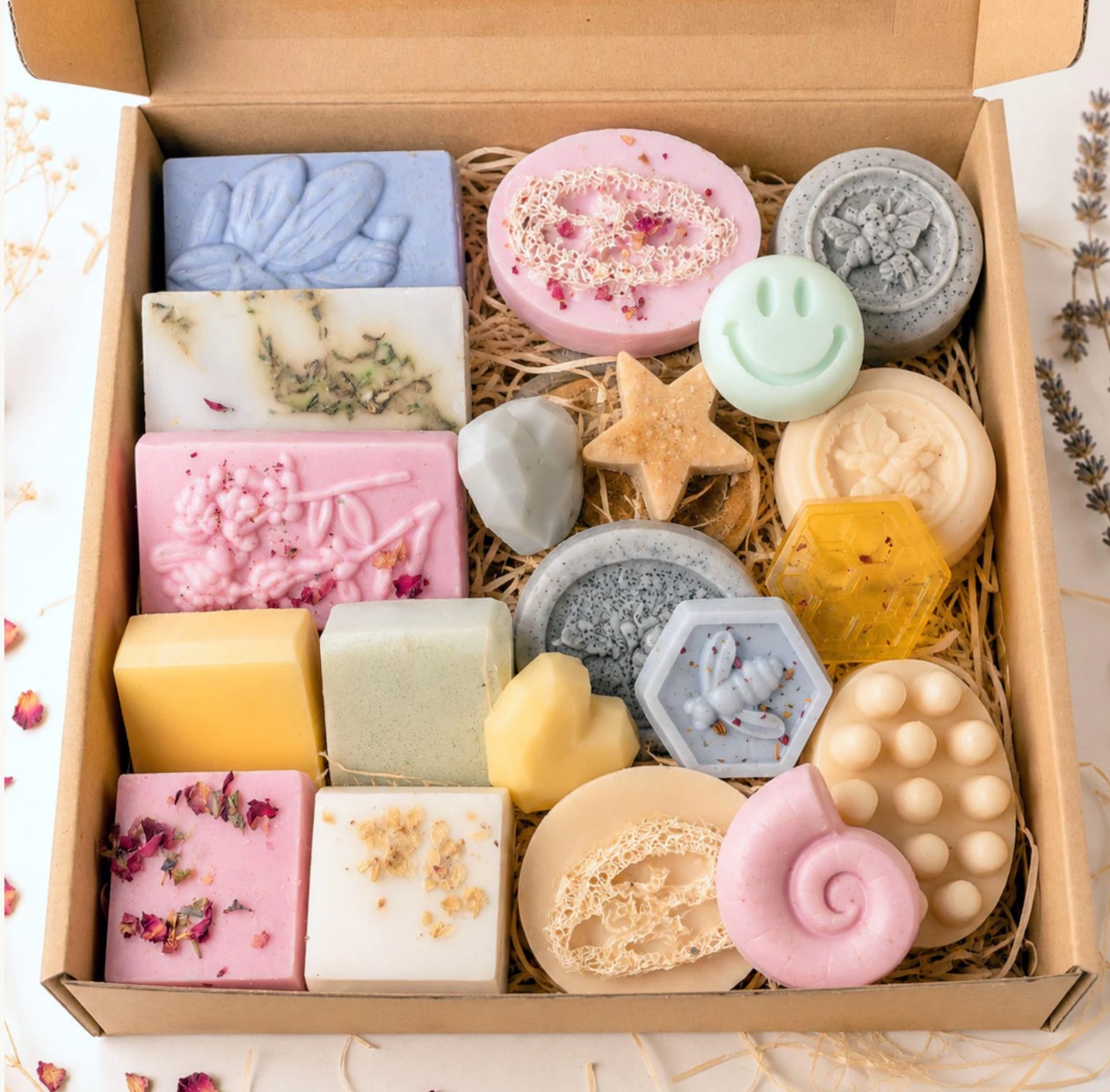 Large kraft gift box with an assortment of pastel handmade soaps in flower, star, heart and honeycomb shapes